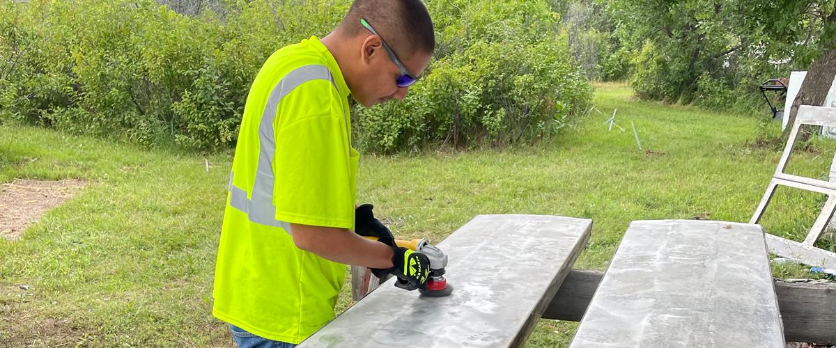 Young native man near sawhorses